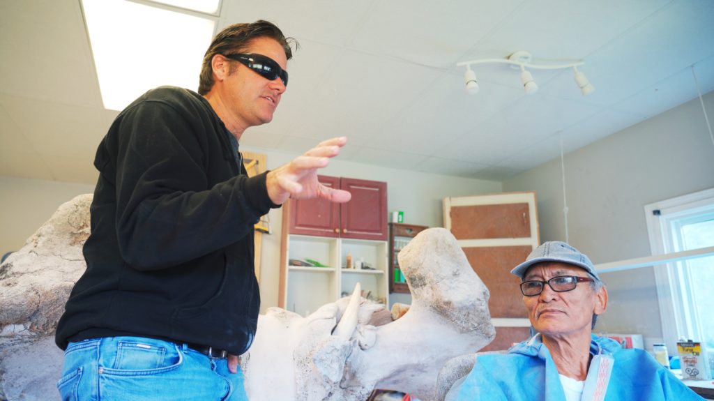 Man with sunglasses next to Inuit Artist