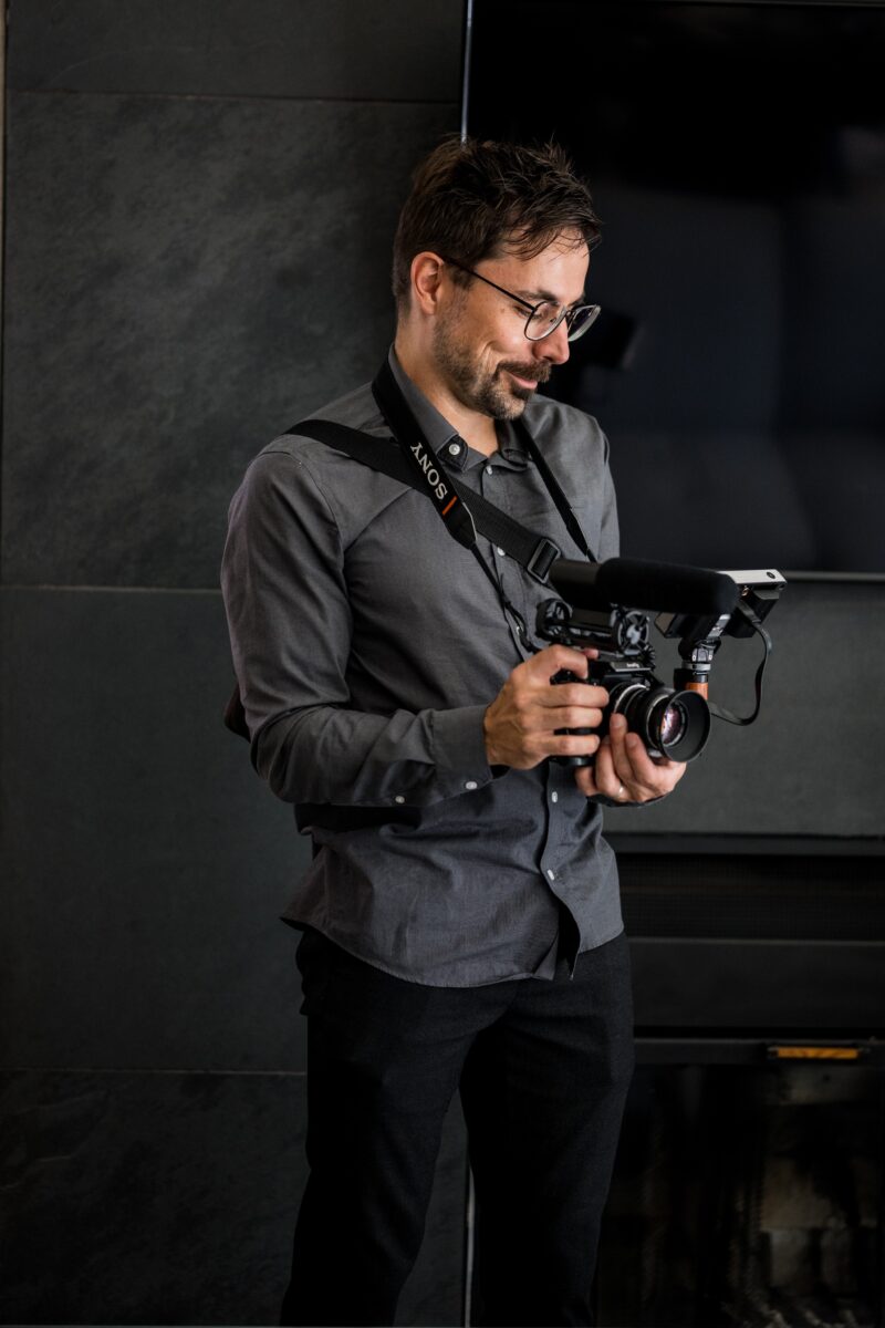Noah holding a camera.