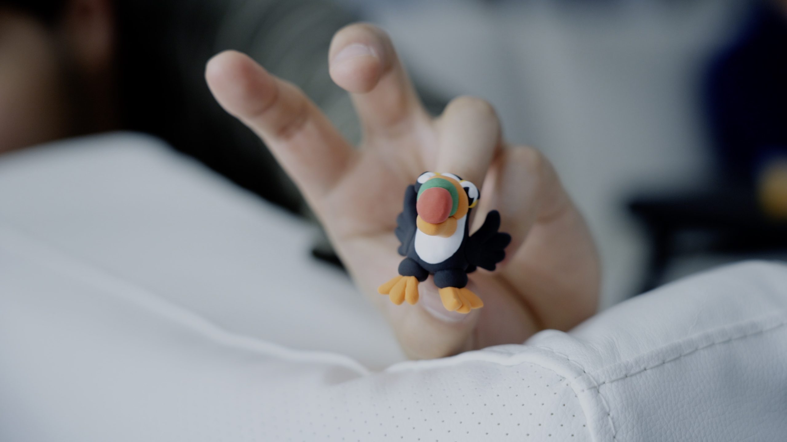 A photo of a puffin made of clay.